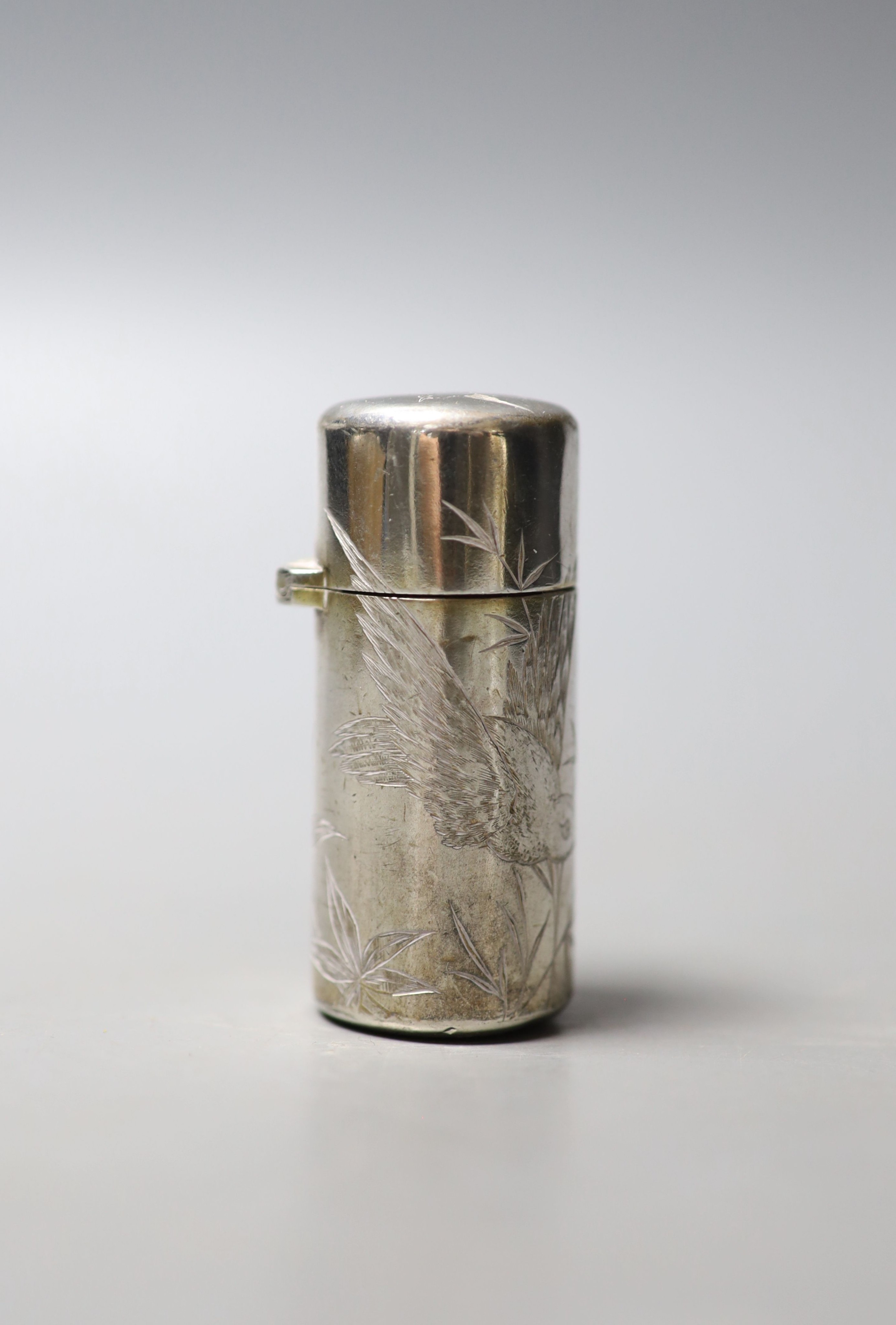 A Victorian silver cylindrical scent bottle, with aesthetic engraved decoration, Hall & Goode, London, 1886, 59mm.